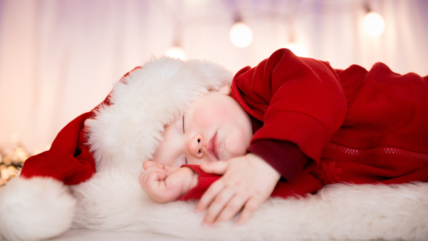 Baby wearing Christmas costume sleeping