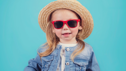 Toddler wearing hat and sunglasses, Nurturing Little Blossoms: Dr. Reyna's Guide to Safely Navigating Allergy Season with Your Baby